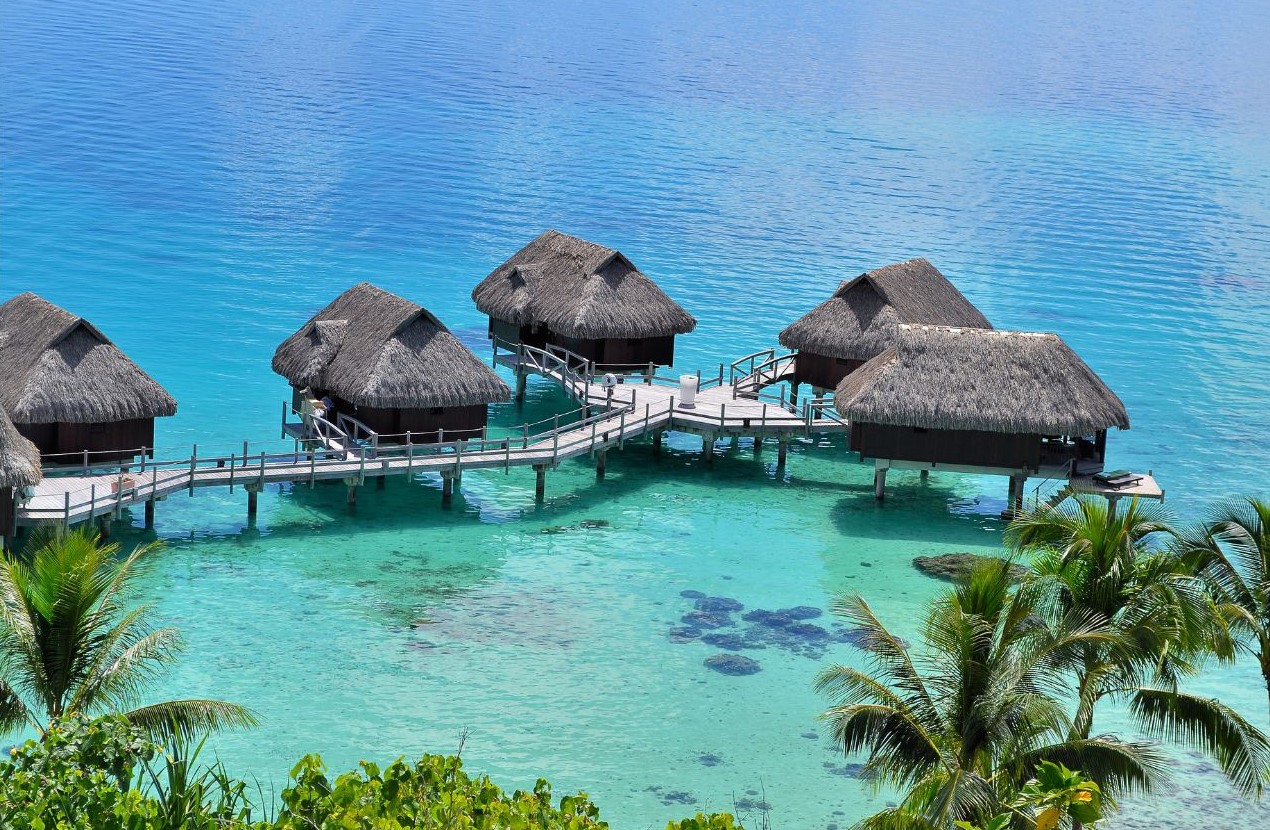 image of a hut village on the sea of clear waters